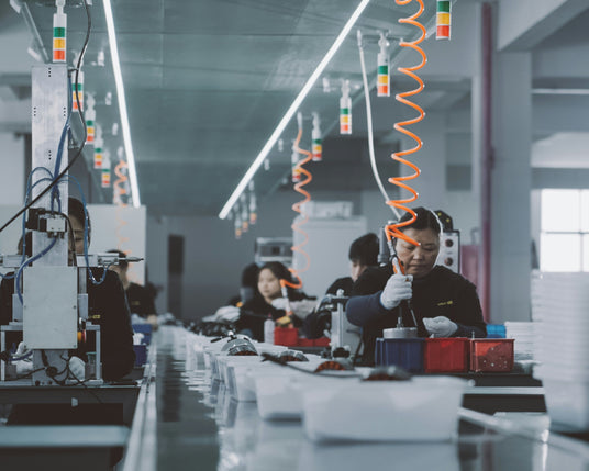 Factory workers operating machinery in a manufacturing setting